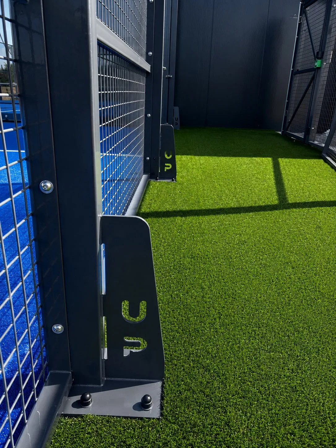 Steel frame and artificial turf installation detail on the France padel court